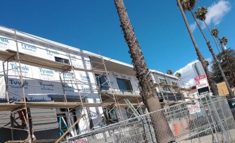 Building under construction with Tyvek wrap and scaffolding