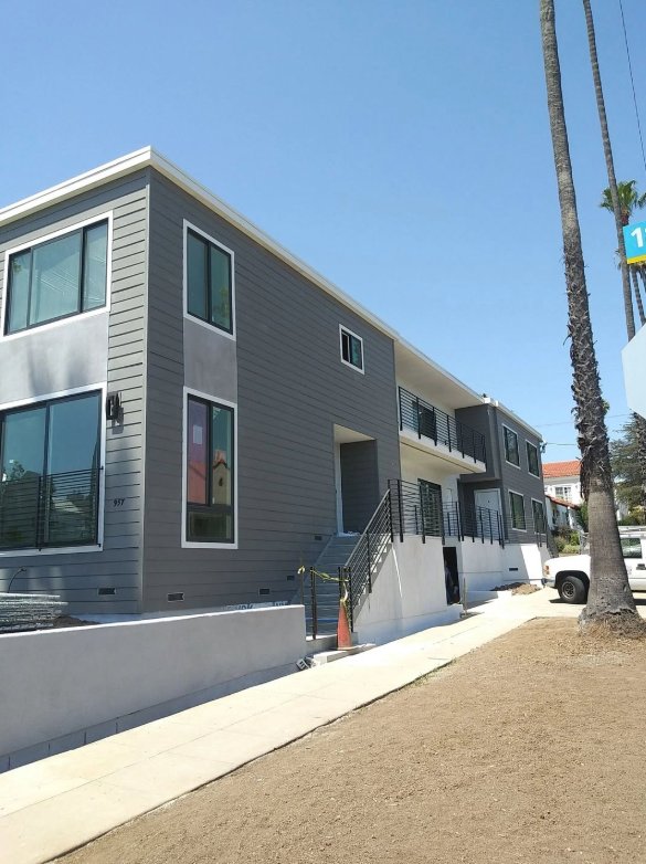 Modern grey duplex with metal railing — recent EA Castillo project
